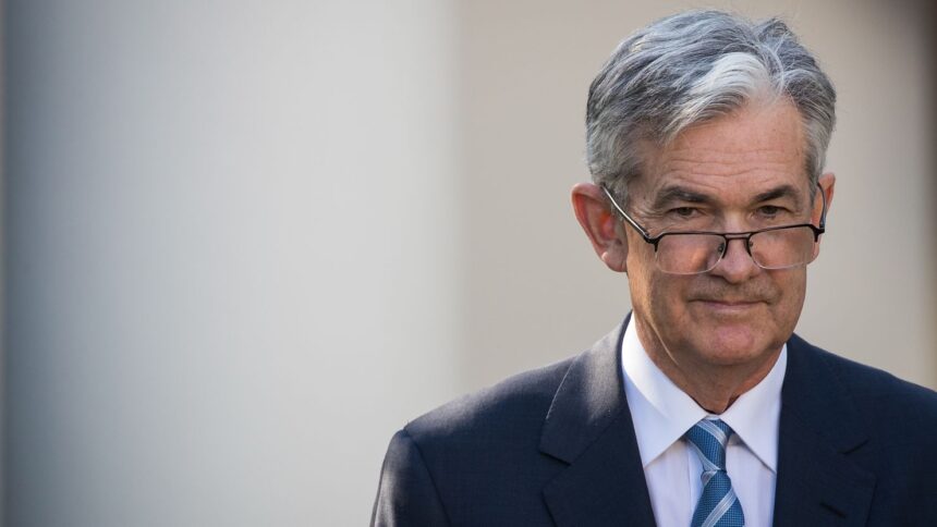 Jerome Powell delivering a speech on economic outlook, impacting crypto and stocks